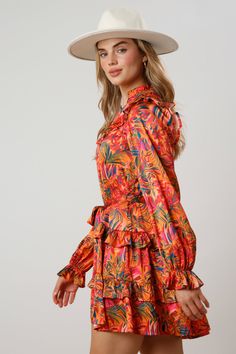 Get wild in this flirty and fun Wild Floral Print Satin Mini Dress. Featuring a tiered ruffled bottom and ruffle details on the collar, shoulders, this dress is sure to turn heads. The belted waist adds a touch of sophistication to this playful piece. Made with 97% Polyester and 3% Spandex, this dress is not only stylish but also comfortable to wear. Embrace your wild side with the vibrant orange, pink, blue, and green floral print. Perfect for any occasion, this dress is short in length with lo Fall Ruffled Mini Dress For Garden Party, Chic Summer Ruffle Dress With Ruffled Collar, Multicolor Ruffled Tiered Dress For Vacation, Multicolor Tiered Dress With Ruffles For Vacation, Spring Mini Dress With Ruffled Collar, Summer Ruffle Dress With Ruffled Hem And Collar, Spring Mini Dress With Ruffle Hem And Collar, Spring Mini Dress With Ruffle Hem And Ruffled Collar, Flirty Ruffle Dress For Vacation