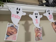 some pictures hanging on a clothes line with ghost faces and one baby in the middle