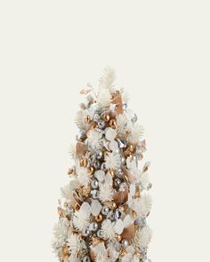 a white christmas tree with gold and silver ornaments