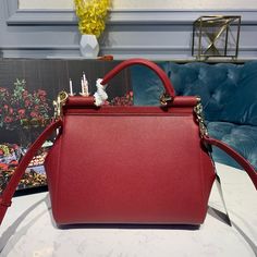 SHOP MORE LUXURY PRODUCTS HERE Description Dolce and Gabbana Small Sicily Bag In Dauphine Red For Women 7.5in/19cm DG Size: 13 x 19 x 6 cm / 5.1 x 7.5 x 2.4 inches (Length x Width x Height) Front flap with hidden magnetic fasteningBranded tag featuring two metal plating finishesTop handle and adjustable, detachable strap in DauphinePrinted fabric lining and flat pocketItem comes with a branded dust bag Includes box, dust bag.This product is of the premium quality. Designer Burgundy Bag With Detachable Strap, Designer Burgundy Top Handle Shoulder Bag, High-end Red Shoulder Bag, High-end Red Bag With Removable Pouch, High-end Red Shopping Bag, Designer Burgundy Bags With Top Carry Handle, Designer Burgundy Bag With Top Carry Handle, High-end Red Shoulder Bag With Double Handle, High-end Red Satchel