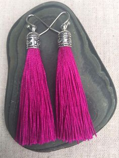 Chic fuchsia pink tassel earrings!  They would add a pop of color to any outfit for any occasion.  Dress them up or down.  They are timeless and versatile.  They are lightweight, fun and unique!The tassels measure 2 1/8” long by 1/4” wide.  They hang from simple silver ear wire hooks.  Overall drop length is about 2 1/4”.  Metal is allergy free plated silver.These are my latest creation!  I have them available in many colors!  Find them all under the category tassel earrings in my shop.Thanks fo Purple Fringe Tassel Earrings Gift, Pink Tassel Earrings With Latkans, Pink Tassel Earrings As Gift, Pink Tassel Earrings For Gift, Pink Bohemian Tassel Earrings, Magenta Earrings, Pink Statement Earrings, Celtic Knot Jewelry, Pink Tassel Earrings