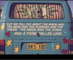 the back end of a blue van with words written on it and stars in the window