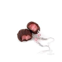 two pieces of chocolate with pink candy on them