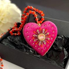 This bright pink heart pendant necklace will  definitely add a charm to any outfit or can be a perfect gift for any occasion.  Long orange glass beads necklace is crocheted by hand  with orange glass beads and embellished with hot pink velvet heart pendant. The pendant is embroidered with glass beads and the sparkle crystal in the center. This unique handmade piece of jewelry could be a perfect gift for whose who loves handcrafted artsy jewelry.  💝Jewelry comes in a lovely box and is ready for Valentine's Day Beaded Party Necklace, Heart Beads Pendant Necklace For Gifts, Handmade Heart Necklace For Party, Handmade Heart Necklace For Valentine's Day, Heart Charm Beaded Necklace For Gift, Red Heart-shaped Beaded Necklace Gift, Heart Beaded Necklaces For Valentine's Day Gift, Heart-shaped Beaded Necklace For Gift, Heart Shaped Beaded Necklace For Gift