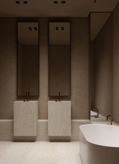 an empty bathroom with two sinks and a bathtub in the middle, surrounded by mirrors