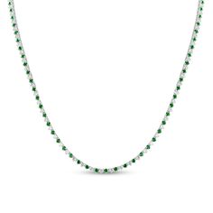 Steal the spotlight with the regal color and timeless sparkle of this green emerald and diamond alternating tennis necklace in white gold. Crafted in 14K white gold Shimmering 1/20 ct. diamonds alternate with dainty verdant-green emeralds along this classic design. Captivating with 3.91 cts. t.w. of diamonds This 18.0-inch necklace secures with a box clasp. Classic White Gold Emerald Necklace With Diamond Accents, Classic Green Emerald Necklace With Diamond Accents, Fine Jewelry Green Diamond Necklace With Brilliant Cut, Classic White Gold Emerald Necklace With Brilliant Cut, Green Round Diamond Cut Necklace, Elegant Green Tennis Necklace, Elegant Green Tennis Necklace With 17 Jewels, Green Diamond Necklace With Diamond Cut, Green Diamond Cut Necklace