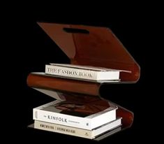 three books stacked on top of each other in front of a black background with the title, the fashion book