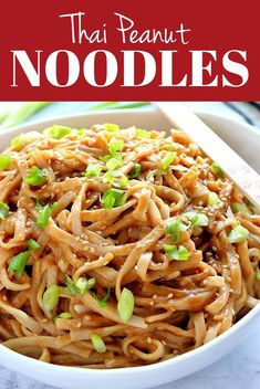 a bowl filled with noodles and topped with scallions