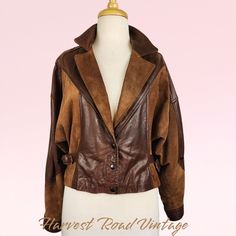 Embrace nostalgic 90s style with this stunning vintage crop jacket! Crafted with a mix of luxe suede and leather materials in a rich brown hue, this jacket exudes timeless elegance. The oversized silhouette in a Size 12 offers a comfy and on-trend look, perfect for the winter season. Channel your inner fashionista with this Women's Winter Classic piece that will elevate any outfit with its vintage charm. This jacket has been professionally DRY CLEANED since acquired by Harvest Road Vintage and h Vintage Brown Leather Jacket For Fall, Brown Leather Long Sleeve Cropped Jacket, Brown Leather Cropped Jacket With Long Sleeves, Brown Leather Jacket With Suede Overlays, Vintage Fitted Suede Leather Jacket, Spring Brown Leather Jacket With Suede Overlays, Retro Brown Leather Jacket For Fall, Vintage Brown Suede Leather Jacket, Nostalgic 90s