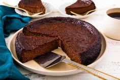 a chocolate cake on a plate with a slice cut out