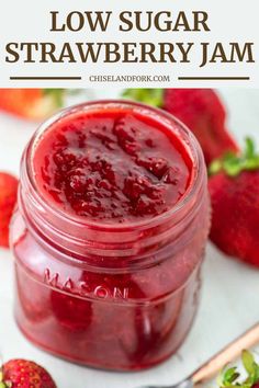 strawberry jam in a glass jar with strawberries around it and text overlay reading low sugar strawberry jam