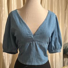 Sz 10 Medium Perfect Lightweight Denim, Medium Blue Wash Measures 19” From Top Shoulder Seam To Bottom, Sleeve Measures 13” From Side Shoulder Seam To Bottom Of Sleeve, Elasticized Bottom Sleeve, Deep V Neck, Open Back Has Cross Cross Tie So You Can Let It Out Or Cinch To Custom Fitcan Wear Bralette Or Cami Underneath Fitted Medium Wash Denim V-neck Top, Medium Wash Denim V-neck Top, Chic Spring Denim V-neck Top, Trendy Denim V-neck Top, Chic V-neck Denim Top For Spring, Trendy V-neck Denim Top For Summer, Trendy Denim Blue V-neck Top, Casual Medium Wash V-neck Denim Top, Casual V-neck Denim Top In Medium Wash