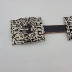 Western Silver Rectangular Concho Leather Belt Constructed using authentic distressed leather. Adorned with sturdy silver conchos. Measures 0.8 inches (20 mm) in width. Measurement of strap from start of strap to middle hole: S/M:32", M/L:36", L/X:40" From middle hole to tip end is 6" more 5 total conchos including the buckle Silver Leather Belt With Buckle Closure, Western Style Silver Belt Buckles For Festival, Western Silver Belt Buckles For Festival, Silver Concho Belt Buckles For Festival, Classic Hand Tooled Silver Belt Buckles, Classic Silver Hand-tooled Belt Buckle, Adjustable Silver Leather Belt, Western Style Rectangular Antique Belt Buckle, Western Antique Rectangular Belt Buckle