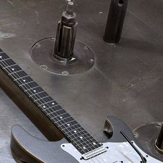 an electric guitar sitting on top of a metal table