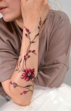 a woman with a flower tattoo on her arm