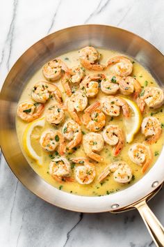 a pan filled with shrimp and lemon soup