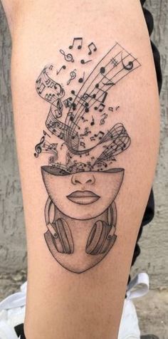 a woman's thigh with music notes and headphones on her face, as if she was listening to music