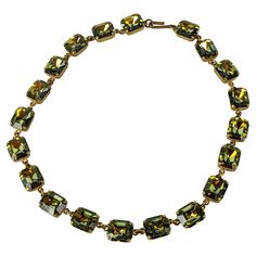 French Green Aurora Stone Necklace from the 1960's. Unusual green aurora emerald cut stones are used simply for a cool splash of color. France 1960's. 14.5" x 3/8". Part of a suite with matching earrings and pendant necklace. Vintage Green Jeweled Necklace, Antique Green Jeweled Necklace, French Necklace Green, Luxury Green Collectible Necklace, Luxury Green Faceted Necklaces, Green Necklace, Emerald Cut, Link Necklace, Stone Necklace