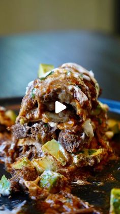 a pile of food sitting on top of a black plate