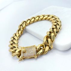 "A perfect gold chain made from 14k gold filled, available in 14mm and 10mm Miami Cuban chain style provides a large, fashionable look. Each piece comes with an iced double safety lock box clasp. Choose your size and feel the vibe. - Available Sizes: - Bracelet 10mm/7 Inches Long - Bracelet 10mm/8 Inches Long - Bracelet 10mm/9 Inches Long - Bracelet 14mm/7 Inches Long - Bracelet 14mm/8 Inches Long - Bracelet 14mm/9 Inches Long 💎 With new products daily, quality and competitive prices, in DiJu J Formal Gold Cuban Link Bracelet With Box Chain, Gold Luxury Curb Chain Bracelet, Gold Cuban Link Bracelet With Cubic Zirconia, Gold Cuban Link Jewelry With Cubic Zirconia, Yellow Gold Cubic Zirconia Cuban Link Bracelet For Gift, Gold Rectangular Curb Chain Bracelets, Rectangular Gold Bracelets With Curb Chain, Gold Cuban Link Chain Bracelet For Gift, Gold Cuban Link Chain Bracelet With Cubic Zirconia