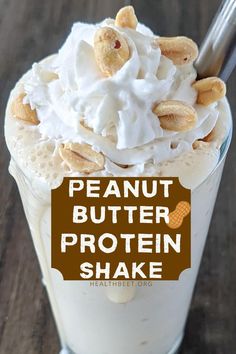 peanut butter protein shake in a glass topped with whipped cream