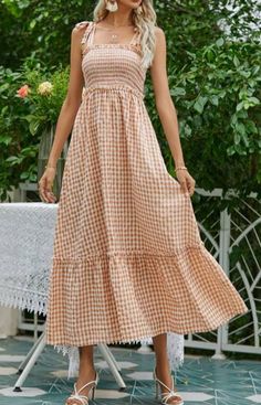 Talk about a dream dress--with english tan gingham checks, this pretty midi has a smocked top and a full skirt with a ruffled hem. Shirred shoulder ties complete the look of this summer classic! 65% Polyester 35% Rayon Shirred Dress, Fitted Midi Dress, Comfy Dresses, Flounce Sleeve, Boho Maxi, Gingham Dress, Boho Maxi Dress, Cami Dress, A Dress