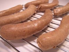 several hot dogs on a cooling rack ready to be cooked