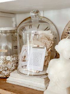 a glass clochet on top of a shelf filled with books and other items