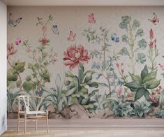 a chair sitting in front of a wall with flowers and butterflies painted on the walls