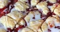 a close up view of a pie with berry toppings and white icing on it