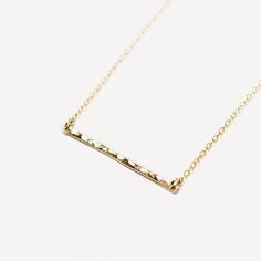 A slender, lightly hammered bar hangs from a delicate chain on this minimal necklace. Available in 14k gold fill, 14k rose gold fill and sterling silver. + All components are 14k gold fill / 14k rose gold fill / sterling silver + Bar measures 3.5cm long + Beautifully packaged in a Minetta box ready for gift giving About Gold Fill: 14k gold filled jewellery has 100+ times more gold than gold plated. Composed of a solid layer of gold bonded with heat and pressure to a base metal, it has the look, Buy Gold Jewelry, Delicate Gold Necklace, Necklace Everyday, Gold Bond, Gold Bar Necklace, Silver Bar, Art Nouveau Jewelry, Hammered Gold, Everyday Necklace