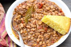 a white plate topped with beans and cornbread