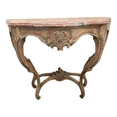 an antique console table with marble top and carved details on the legs, isolated against a white background