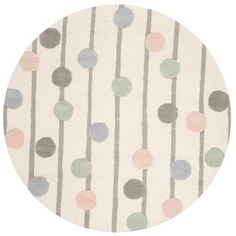 a round rug with multicolored dots on it in grey, pink and white