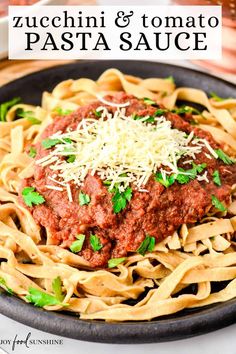 pasta sauce in a skillet with parmesan cheese on top and the title overlay reads zucchini & tomato pasta sauce