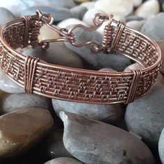 a close up of a bracelet on some rocks