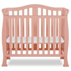 a pink crib with white sheets on the bottom and side rails, in front of a white background