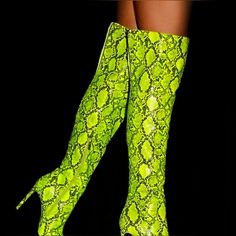 Iconic Graphic Stiletto Boot A Stretch-To-Fit Over-The-Knee Boot With A Side Graphic Detail, Pointed Toe, Stiletto Heel, And Zipper Closure. Material: Faux-Leather Calf Circumference: Reg: 16.5"; Wide Calf: 17.5" Fit: True To Size Color: Chartreuse Outside Heel Height: 4.25" Closure: Functional Zipper Sizing: Based On Size 6; Shaft Height & Calf Circumference Increases Or Decreases By 0.5" Per Whole Size. Shaft Height: 20.5" Imported Synthetic Knee-high Party Heels, Neon Yellow Party Heels In Synthetic Material, Yellow Boots For Spring Party, Yellow High Heel Party Boots, Yellow High Heel Boots For Party, Neon Yellow Fitted High Heels, Fitted Neon Yellow High Heels, Neon Yellow Party Heels, Yellow Pointed Toe Party Boots