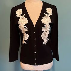 Inc Black Cardigan Sweater With Sheer Creme Appliqus & Rhinestone Button Closure. New Without Tags. Never Worn. Pleated Shoulder 18” Pit To Pit 22” Shoulder To Hem. This Is A Beautiful Quality Sweater. Wear Alone Or Over Tank. Medium Elegant Spring Cardigan With Buttons, Elegant Spring Sweater With Button Closure, Elegant Cream Button-up Cardigan, Elegant Cream Button-up Sweater, Couture Ideas, Black Cardigan Sweater, Altered Couture, Floral Applique, Inc International Concepts