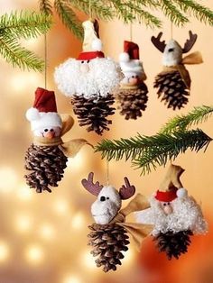 christmas decorations hanging from a tree with pine cones