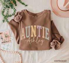 Personalized Auntie Sweatshirt For Aunt Gifts, Christmas Gift For Aunt, New Auntie Crewneck, Comfort Colors® Auntie Sweater Retro Aunt Shirt, Pregnancy Announcement  SIZING  ❥ This sweatshirt has a modern unisex fit. Runs true to size. ❥ Please refer to size chart before ordering. Measure your favorite sweatshirt armpit to armpit and top to bottom and compare it with the size chart provided to ensure an accurate fit.  DELIVERY TIMES  ❥ We take about 1-5 business days to create the items. ❥ Everything is printed and hand made just for you. On average your order will be sent out within 3 days of ordering. ❥ Estimated shipping delivery time in US is 3-5 business days. RETURNS & EXCHANGES  ❥ Due to the nature of the product being made on demand, we can only accept returns or exchanges if your Auntie Sweatshirt Ideas, Cool Aunt Sweaters, Aunt Hoodies, Aunt Hoodies Sweatshirts, Auntie Sweater, Cool Aunt Sweatshirt, Christmas Gift For Aunt, First Pregnancy Announcements, Auntie Sweatshirt