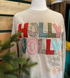 a white t - shirt with the words holly jolly on it and sequins