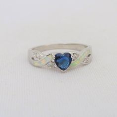 Vintage Sterling Silver Blue Sapphire, White Topaz & Opal Twisted Ring...Marked 925...Total of weights 2.1grams... Size 7...Measure of stone center 5.7MM...It's in very good condition. Blue Heart Cut Sapphire Gemstone Ring, Blue Sapphire Heart Cut Ring, Blue Heart Cut Sapphire Ring, Blue Hallmarked Opal Ring For Wedding, Sterling Silver Heart Cut Jewelry With Accent Stones, Blue Sterling Silver Rings With Accent Stones, Blue Topaz Heart Cut Promise Ring, Anniversary Blue Birthstone Ring With Center Stone, Blue Sterling Silver Heart Ring