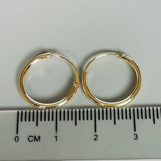 16mm sterling silver endless ear hoops, dipped in gold. Size: 1.5 x 16 mm These earrings are made of real 925 hypoallergenic sterling silver, dipped in real gold. Will be packaged in a gift box. Please let me know if you don't want it in one. I can write out a message from you to the receiver if needed. Please be free to contact me at... bhavnakwintra1956@gmail.com More hoops: https://www.etsy.com/your/shops/TheSilverGame/tools/listings/section:26305414 More earrings: https://www.etsy.com/your/s Gold Huggie Jewelry With Simple Design, Gold Simple Design Huggie Jewelry, Adjustable Nickel-free Round Huggie Earrings, Gold Hypoallergenic Hoop Cartilage Earrings, Gold Hypoallergenic Round Cartilage Earrings, Minimalist Small Hoop Earrings Cadmium-free, Simple Adjustable Small Hoop Jewelry, Adjustable Simple Small Hoop Jewelry, Adjustable Round Hoop Earrings In Dainty Style