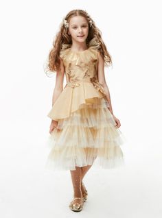 Give a royal feel to your little girl with this gold tulle tea length dress. Creative detailing and spotless seaming makes it a perfect buy. Scoop neckline is given an accentuated look with the long frill along the edges. Tulle Tea Length Dress, Tulle Layered Skirt, Sleeveless Flower Girl Dresses, Gold Tulle, Tea Length Dress, Sequin Appliques, Tea Length Dresses, Layered Skirt, Spring Sale