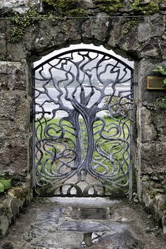 an iron gate with a tree on it