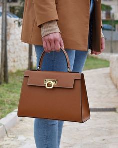 Brown Saffiano Leather Satchel With Top Handle, Luxury Brown Shoulder Bag With Round Handle, Luxury Brown Satchel With Round Handle, Brown Saffiano Leather Top Handle Satchel, Cognac Saffiano Leather Office Bag, Office Saffiano Leather Bag In Cognac, Elegant Cognac Satchel For Office, Elegant Cognac Briefcase With Detachable Strap, Cognac Epsom Leather Office Bag