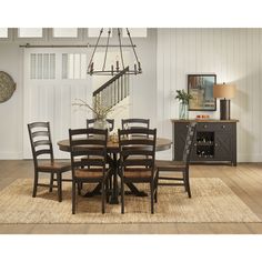 a dining room table with chairs and a chandelier