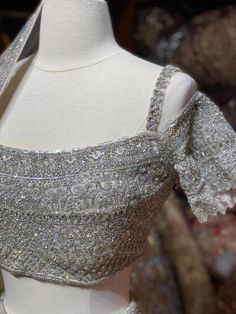 Iced cube sliver lehenga with frosted crystal embroidery teamed with a spaghetti strap blouse with crystal embroidery and net dupatta. Fabric: Net Custom designed according to client measurements and color preference. Production and delivery time is 120 days! Sliver Blouses Designs, Sliver Lehenga, Silver Embellished Pre-draped Saree, Glamorous Silver Choli With Mirror Work, Glamorous Silver Choli With Zari Work, Festive Silver Glamorous Choli, Designer Silver Dress With Mirror Work, Embellished Silver Saree Set, Silver Dress With Mirror Work For Designer Wear