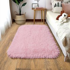 a pink rug is in the middle of a room